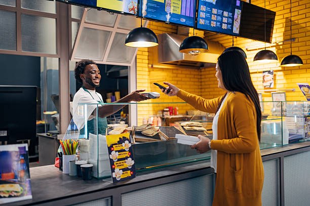 A student paying in person at a food counter